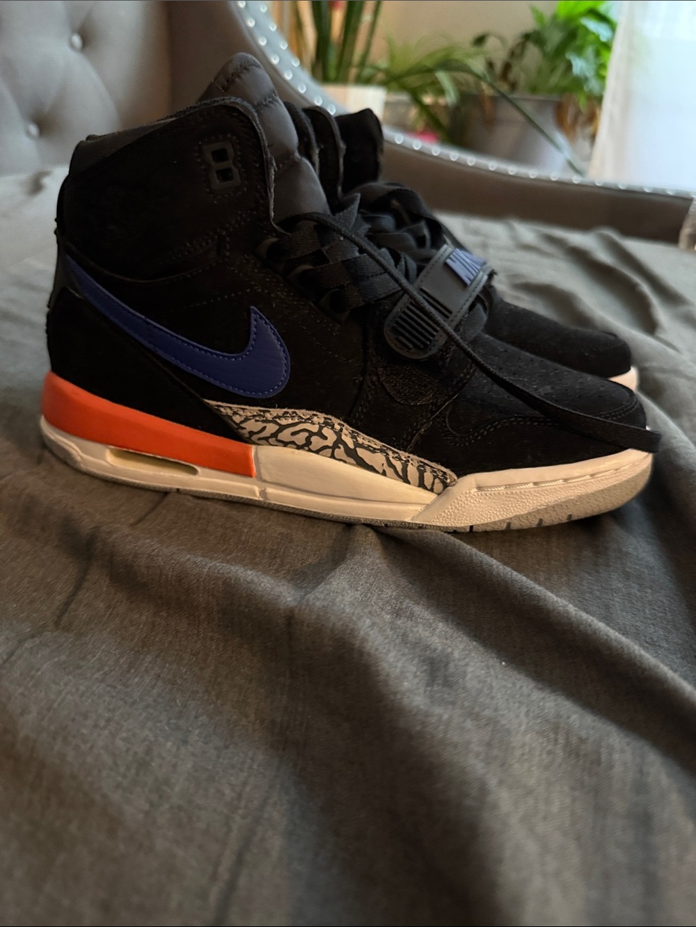 Nike Big Kids Black High-Top Sneakers with Blue Swoosh and Orange Heel Accent